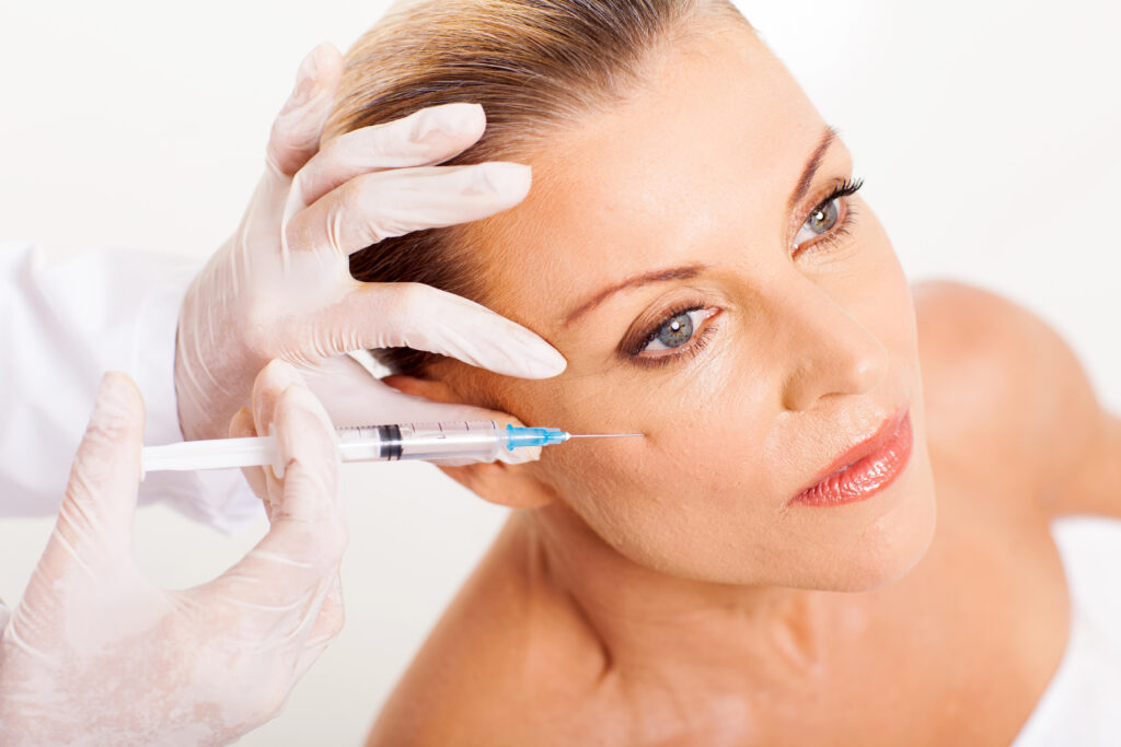 Doctor Giving Mid Age Woman Face Lifting Injection Closeup